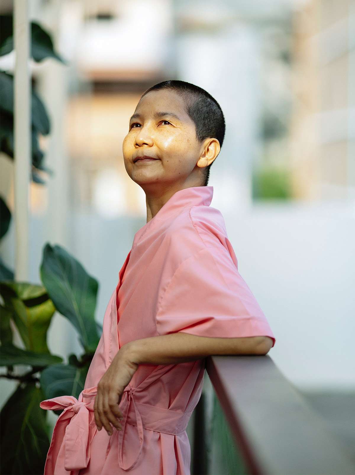 asian woman posing after cancer treatment