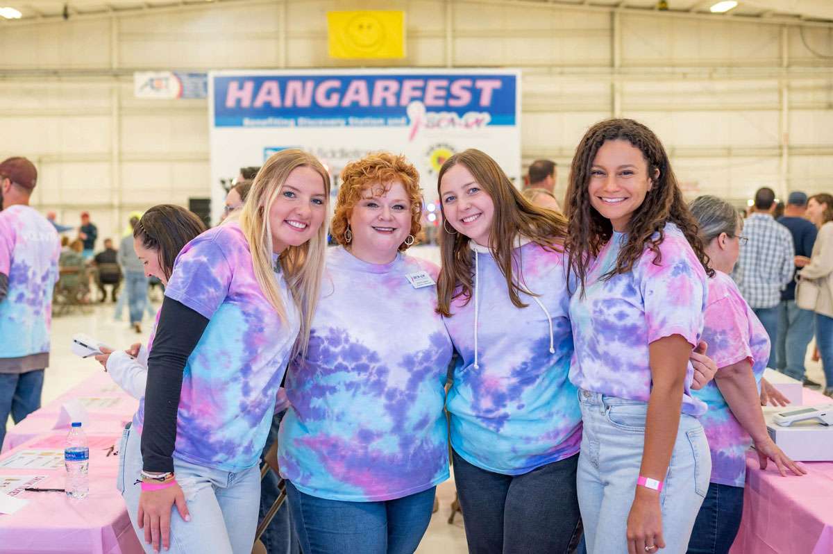 group of women wearing tie-dye shirts at the annual hangerfest event