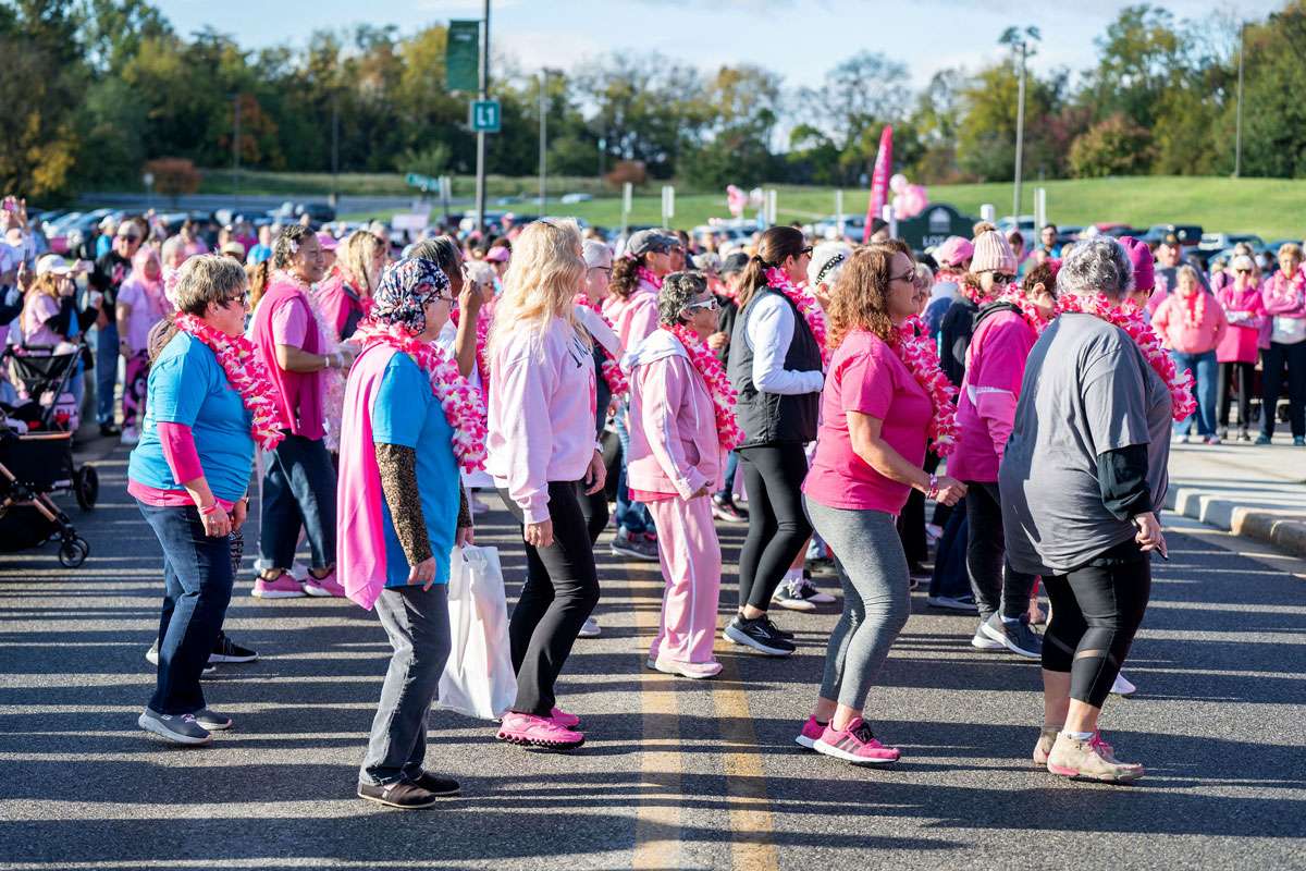 group of women line dancing at breast cancer event