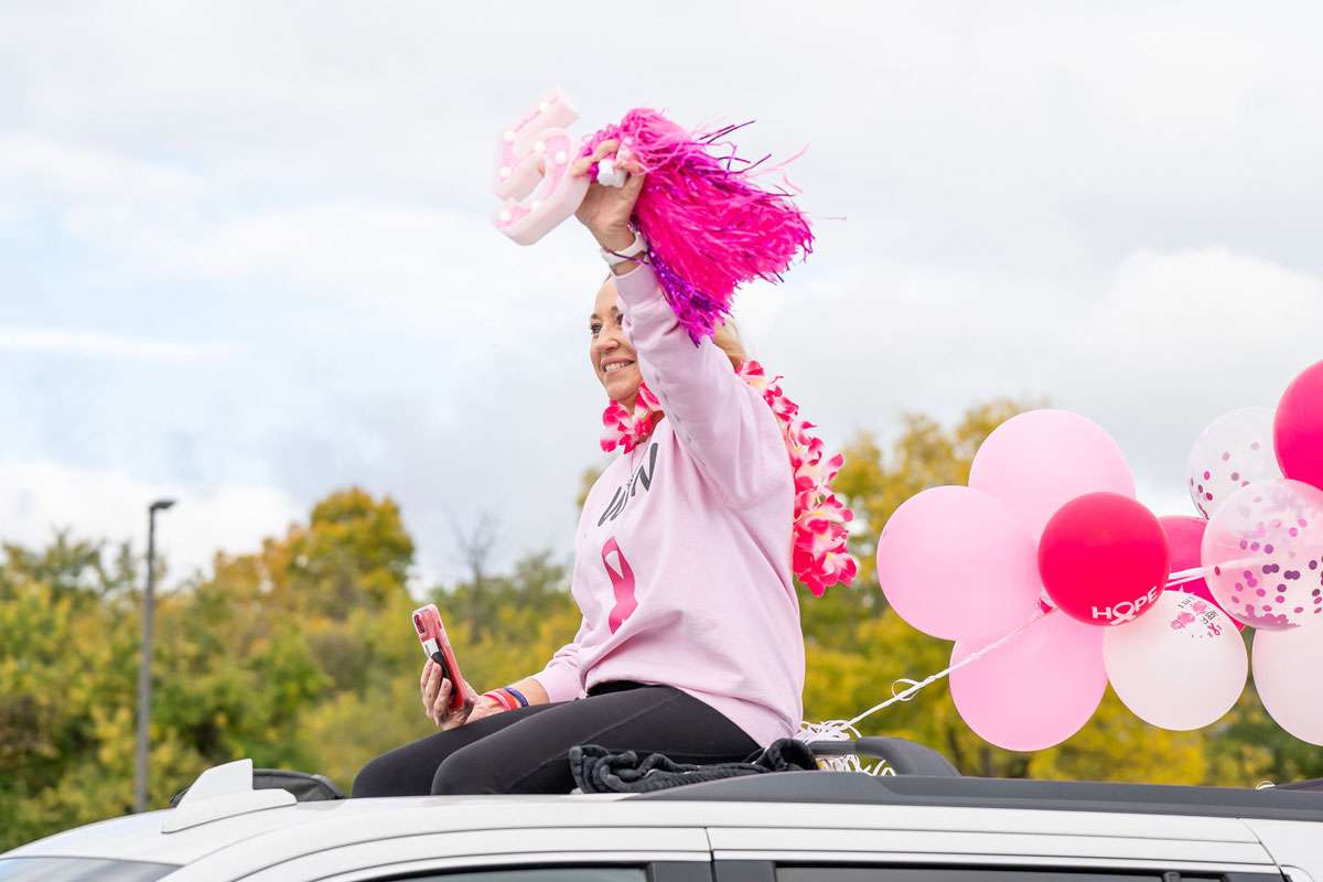 woman riding on roof of car